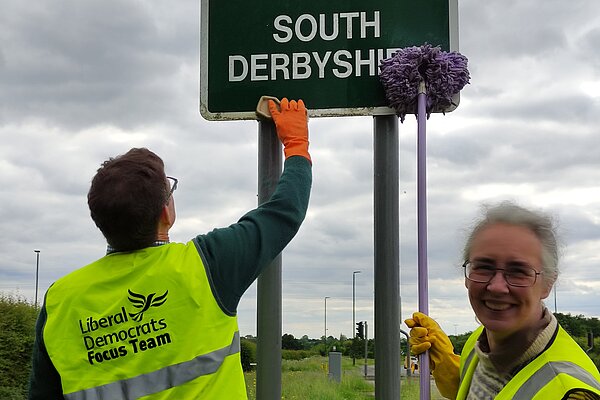 Lucy with the Focus team cleaning street signs