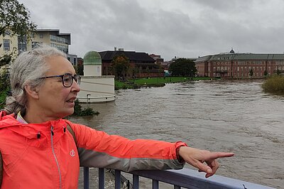 Lucy Care looking out over river Derwent flooding