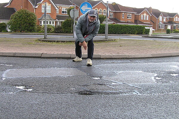 Grahame Andrew looking at Hilton potholes that need repairing again