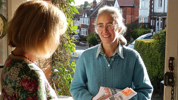 Lucy Care on doorstep discussing the cost of living